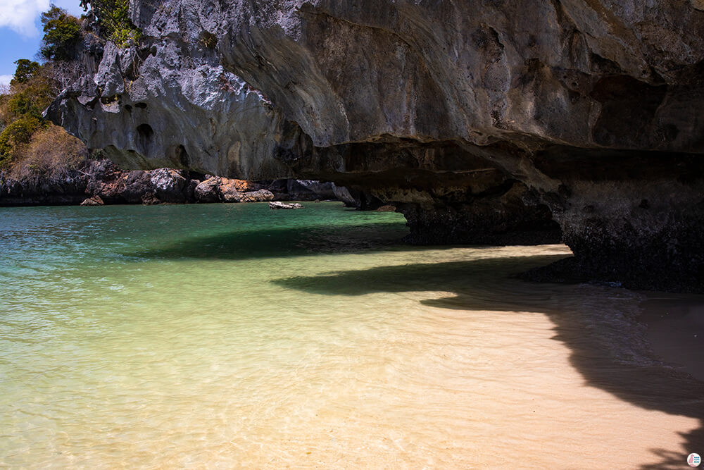 Big cliff with crystal clear water at West Phra Nang Beach, Railay Bay, Krabi, Thailand